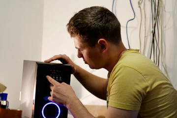 Young engineer repairing musical hi-fi system. man repairing music instrument, audio engineer...