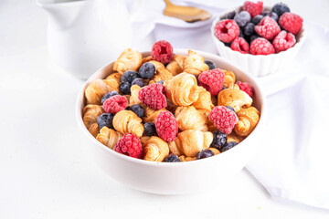 Tiny breakfast croissant cereals with fresh berries and milk