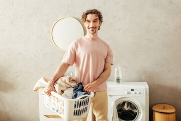 A gentleman in cozy homewear stands next to a washing machine.