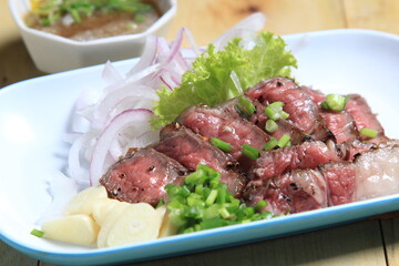 Grilled beef "Crying Tiger" in Thai "Crying Tiger", beef marinated in Thai recipe, cut medium rare, Crying Tiger (Thai style grilled beef served with Japanese style ponzu dipping sauce)