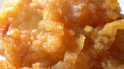 In mouthwatering macro, watch as piping hot fried chicken rests on the plate, its crunchy exterior inviting you to take a bite. Food concept. 
