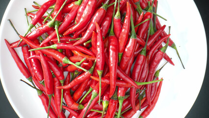 The intense beauty of red chili peppers is unveiled, revealing their vibrant, wrinkled skin and the...