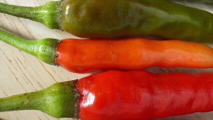 The mesmerizing details of colorful chili peppers through macro. Feel the intensity as the peppers come alive, showcasing their fiery nature in a breathtaking display. 
