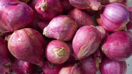 A macro view, red shallots become a culinary masterpiece, showcasing their fine papery skin,...