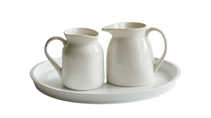 Fototapeta premium Two white pitchers are placed on a ceramic plate, creating a simple yet elegant tabletop arrangement