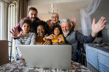 Extended multiethnic family together at home during video call. People happiness technology concept