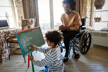 Happy child doing math exercises with her mother or teacher together. Education people fun concept