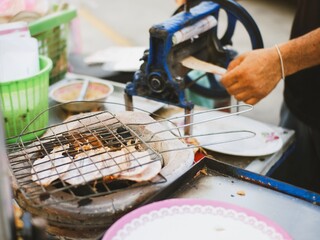 CHONBURI, THAILAND MAY 20, 2024: The merchants are grilling the crispy squid to eat.