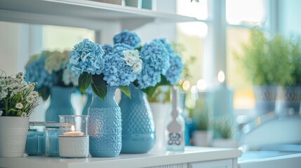 Blue and white flowers in a blue vase sit on a white table against a bright window.