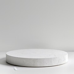 circular white pedestal in front of white background