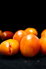 Fresh tomatoes isolated on black background