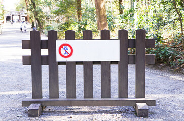 Signs or symbol prohibit motorcycle and cars pass located on wooden board Located in middle of dirt...