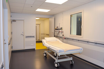 A hospital room with a bed and a door