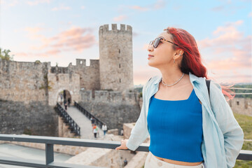 Experience the vibrant energy of Belgrade with a portrait of a happy tourist exploring Kalemegdan fortress.