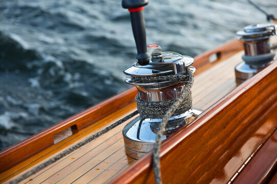 Close-up of rope tied to metal of boat deck