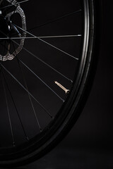 close up of bicycle wheel on dark background