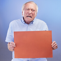 Angry, sign and senior man with poster with info for protest and feedback mockup in studio background. Elderly, person and frustrated with opinion on board in retirement with announcement and news