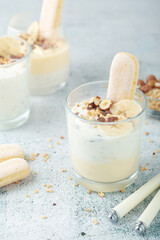 Milk mousse dessert with nuts in glasses	