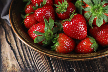 A bowl with ripe bright strawberry in rustic style	