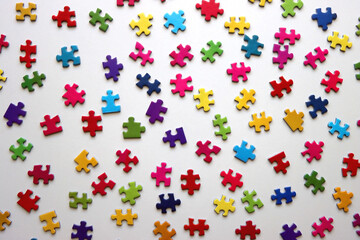 Colorful jigsaw puzzle pieces on white background. Flat lay.