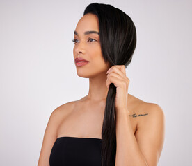 Fototapeta premium Hair care, thinking and woman with salon in studio for growth, keratin treatment or shampoo glow on white background. Hairstyle, aesthetic and hand of model for confidence, cosmetics or texture