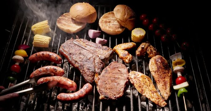 Grill grate is filled with wide variety of gourmet foods. Gourmet will find here what he likes. From juicy meat and chicken steaks sausages and buns to scattering of savory vegetables. Aroma of summer