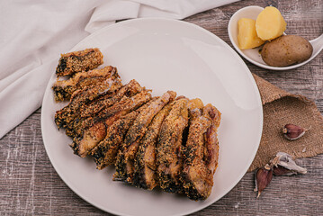 Fried and sliced breaded carp on a white plate. With boiled potatoes. Homemade food. Recipe.