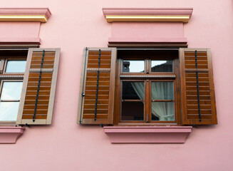 Traditional Wooden Shutters on Pink Building Wall