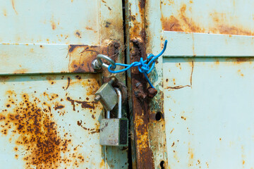 Close-Up of Rusty Padlocks On An Old Metal Door