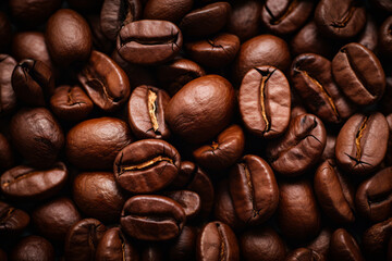 Obraz premium Pile of coffee beans with some brown stuff on them.