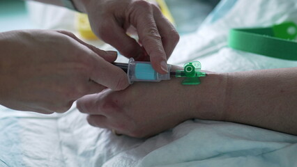 Nurse's hand taking blood from Patient's hand, close-up. hospital equipment and routine of nursing...