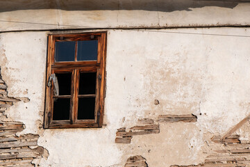 Forgotten Memories. The Abandoned House with a Broken Wooden Window Frame.