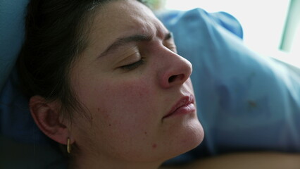Upset woman close-up face with eyes closed frowning in distress, 30s person struggling with pain in...