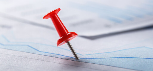 Marking financial chart by pins.Share listing and checking financial chart. Concept of banking,...