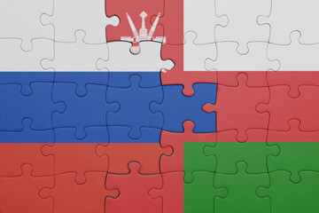 puzzle with the colourful national flag of oman and flag of russia.