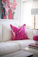 A modern living room with a splash of vibrant pink in the form of throw pillows on a crisp white sofa, highlighting a blank white frame