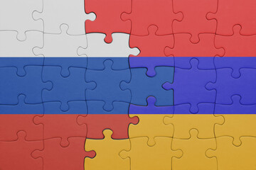 puzzle with the colourful national flag of armenia and flag of russia.