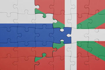 puzzle with the colourful national flag of basque country and flag of russia.