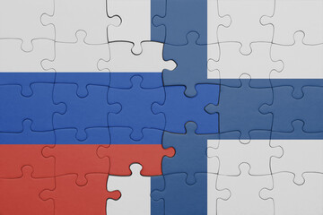 puzzle with the colourful national flag of finland and flag of russia.