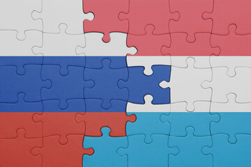 puzzle with the colourful national flag of luxembourg and flag of russia.