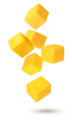 Yellow ripe mango slices flying in the air isolated on white background.