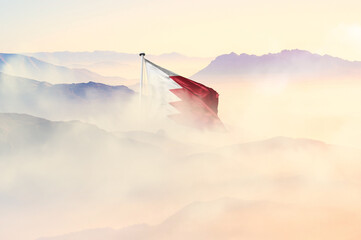 Bahrain flag disappears in beautiful clouds with fog.