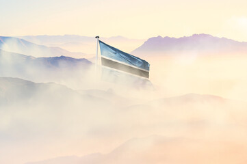 Botswana flag disappears in beautiful clouds with fog.