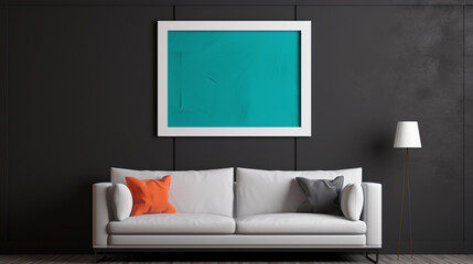 A monochromatic scheme with a charcoal grey couch against a slate grey wall, adorned with a pop of color through a blank empty white frame mockup.