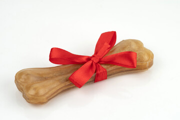 A treat for dogs - a pressed chewing bone. Isolated on white background.