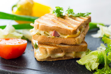 fried toasts with filling, salad leaves, tomatoes