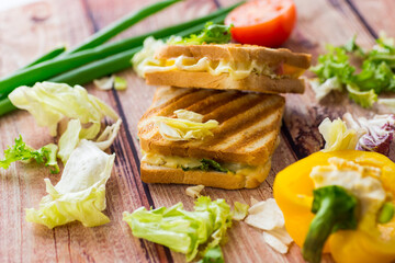 fried toasts with filling, salad leaves, tomatoes