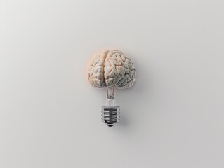 A brain is shown with a light bulb on top of it. The brain is split in half, with the bulb in the middle. Concept of a light bulb representing a new idea or thought