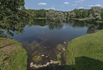 Pavlovsk, Russia - July 6, 2023: People boating on the calm waters of the Round Lake. Pavlovsk Park.