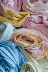 A pile of colorful fabric with a variety of colors including blue, pink, yellow, and green